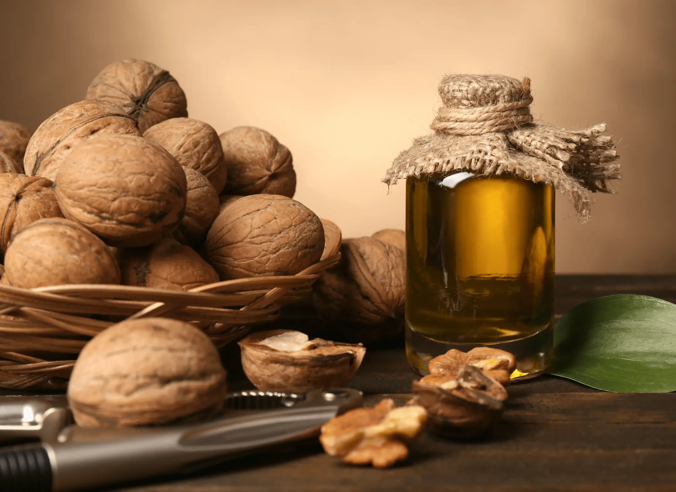 Basket of walnuts beside a jar of walnut oil